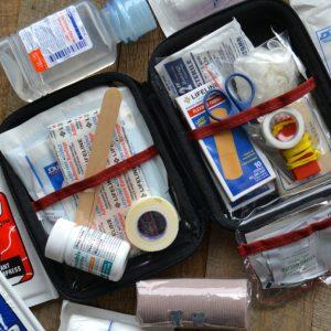 A first aid kit for disaster preparedness on a table.